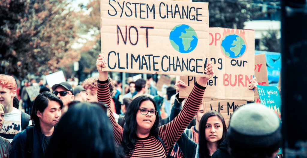Two young women protesting for action against climate change