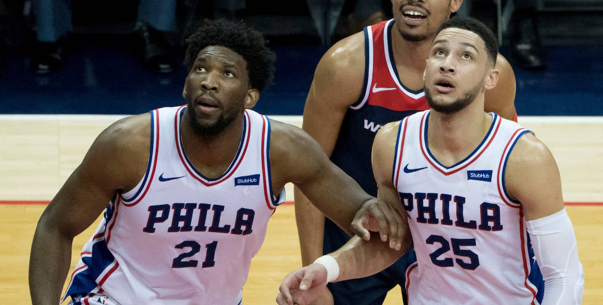 Philadelphia 76ers player Joel Embiid and other players on the basketball court.