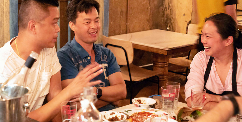 Wilson Tang, Ange Branca and writer Jonathan Deutsch sit around a table at Sate Kampar on East Passyunk Avenue.