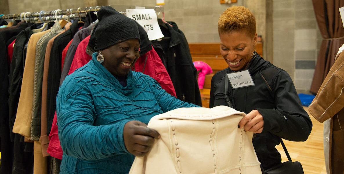 Two women shop at an Our Closet pop-up shop on Coat Day.