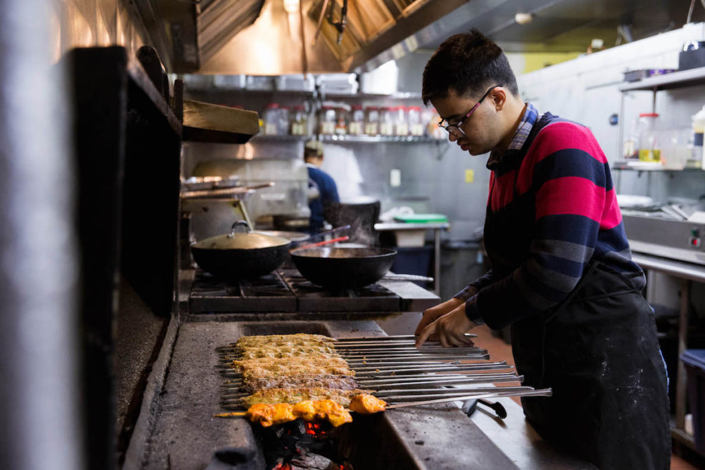 A cook grills meats at Kabobeesh, a Pakistani restaurant in University City