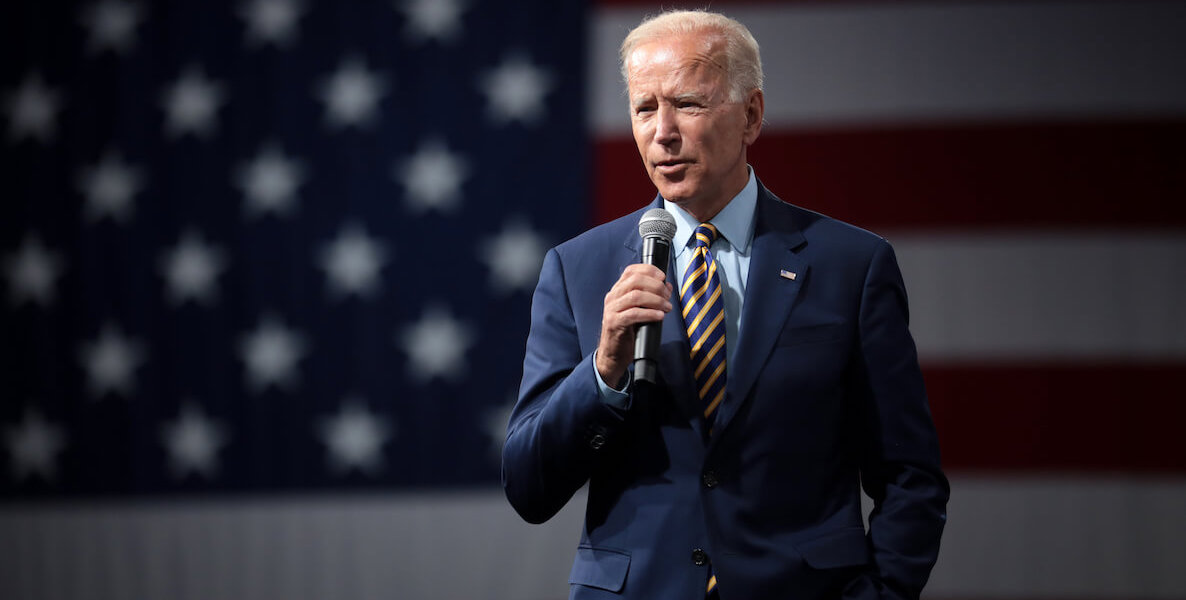 Democratic presidential candidate Joe Biden speaks in front of a massive American flag