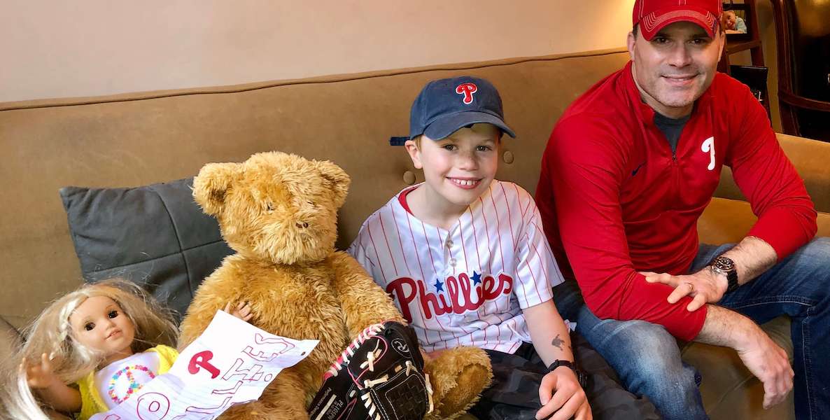 Mike Wang and his son Elliot at a pretend Phillies game in their living room.