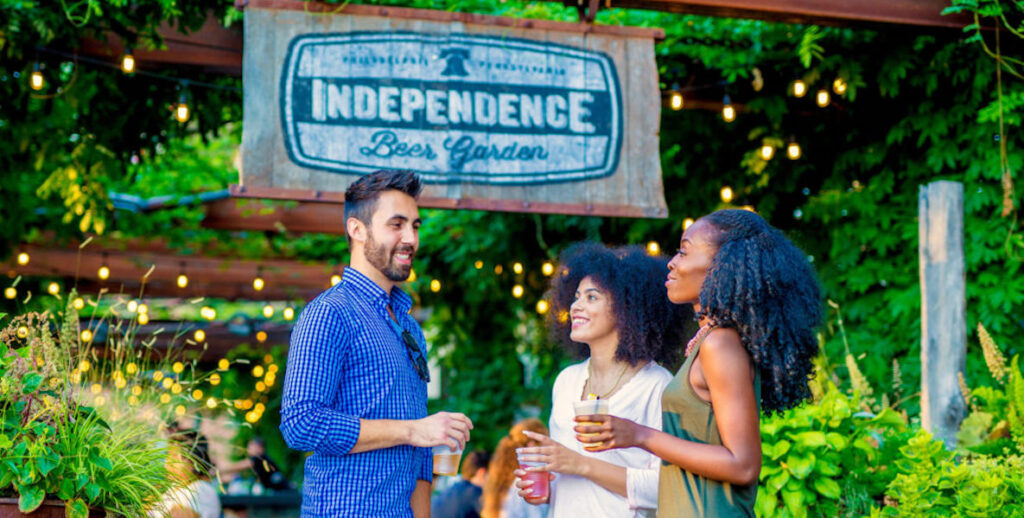 A group of friends mix and mingle at Independence Beer Garden in Old City, Philadelphia.