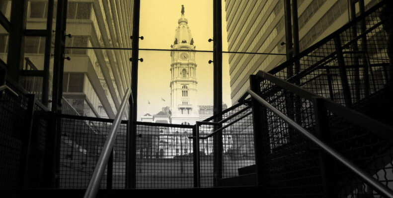 An image of City Hall in Philadelphia, through a yellow glass tunnel leading to suburban station.