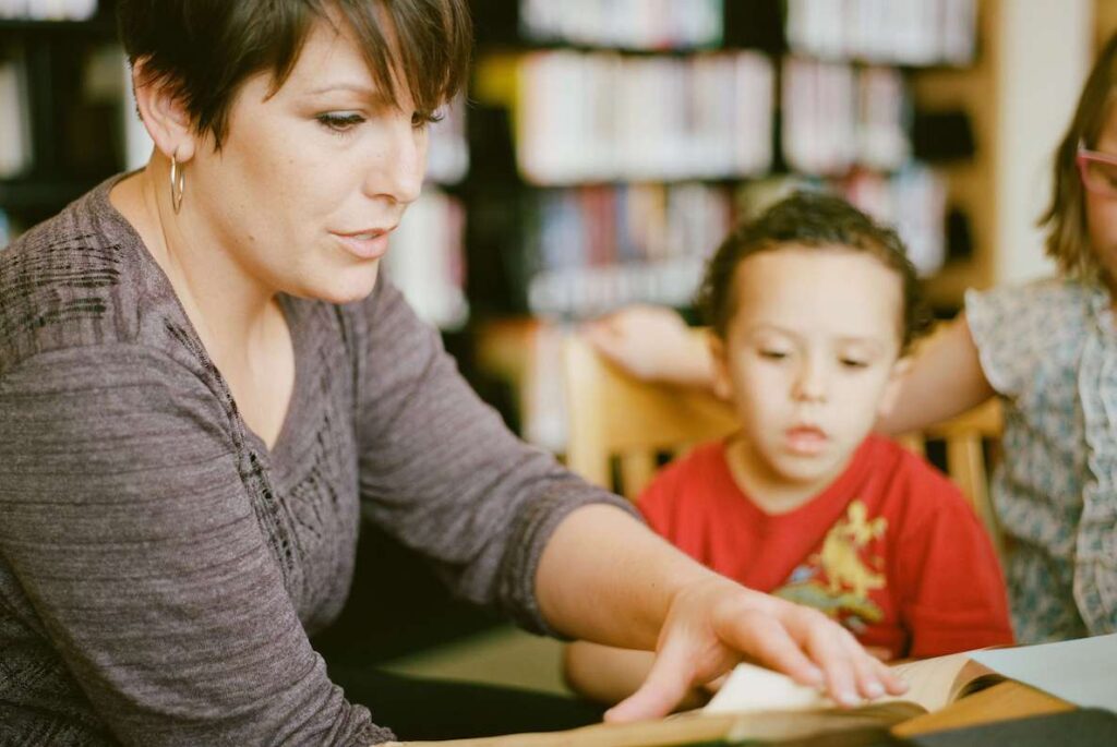 A para educator helps a child learn to read. When looking for ways to help Philly schools, don't overlook the para educators!