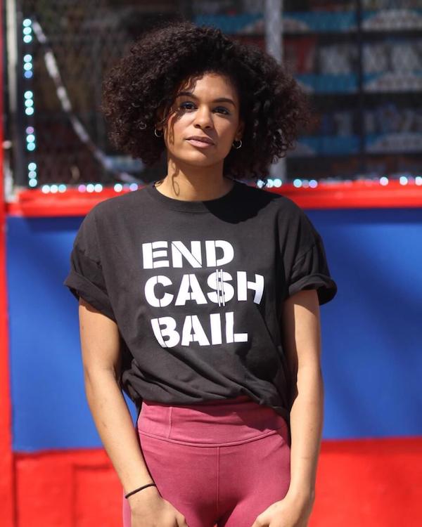 A model sports a tee shirt from Grant Blvd that reads "End Cash Bail"