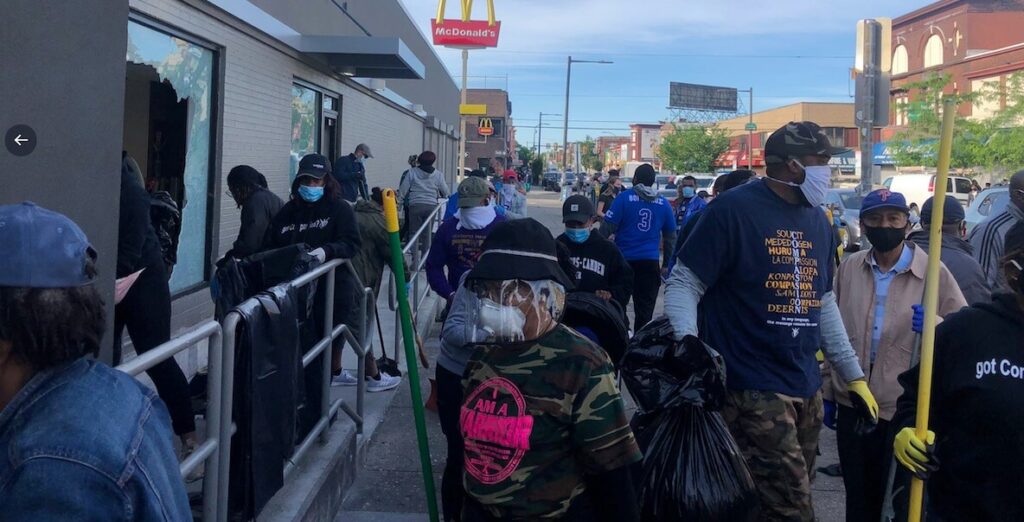 Volunteers helping to clean up the morning after protests turned into looting in West Philly.