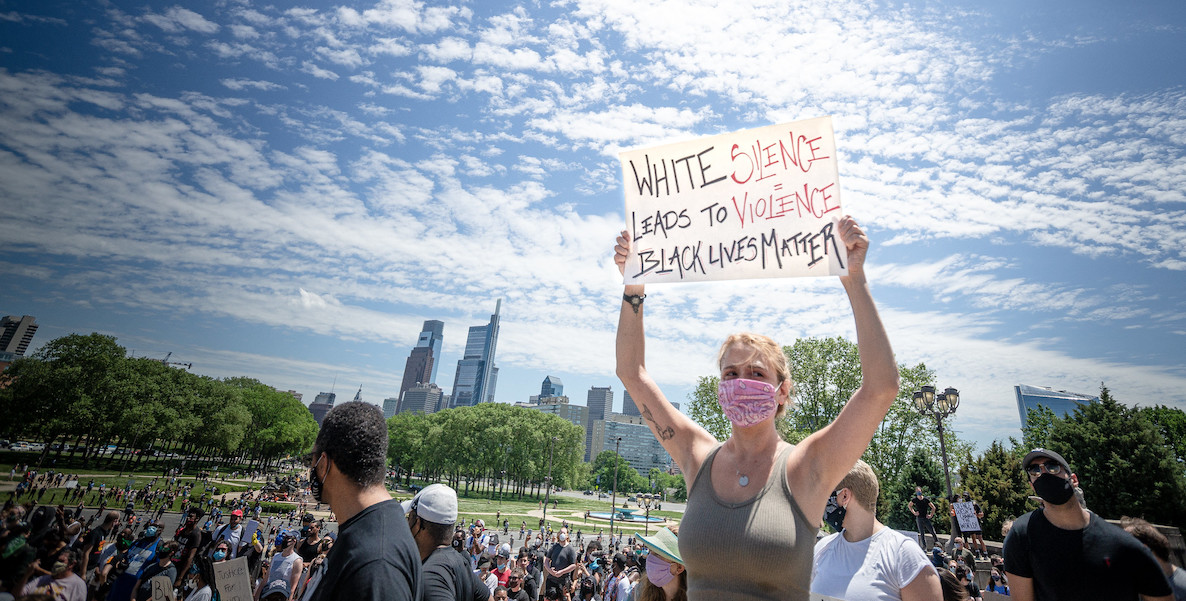 A woman holds a sign during George Floyd protest June 2020