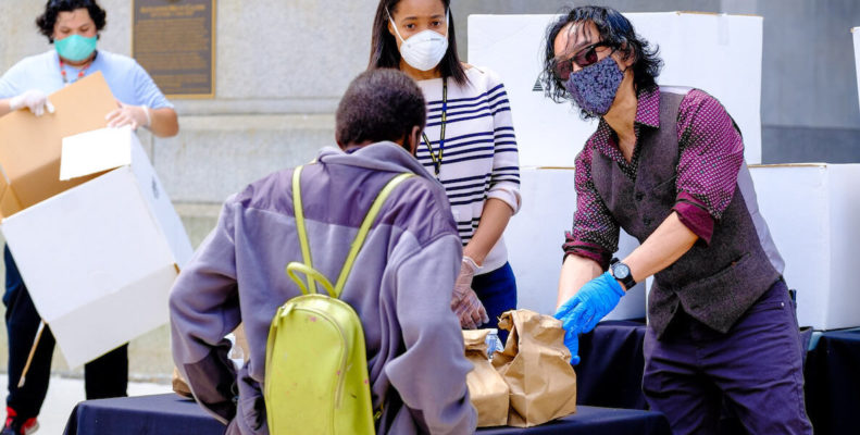 SEAMAAC Executive Director Thoai Nguyen hands out food at City Hall during the coronavirus pandemic