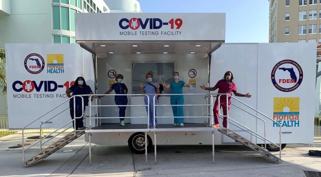 Nurses pose on the porch of Aardvark Mobile Health testing site
