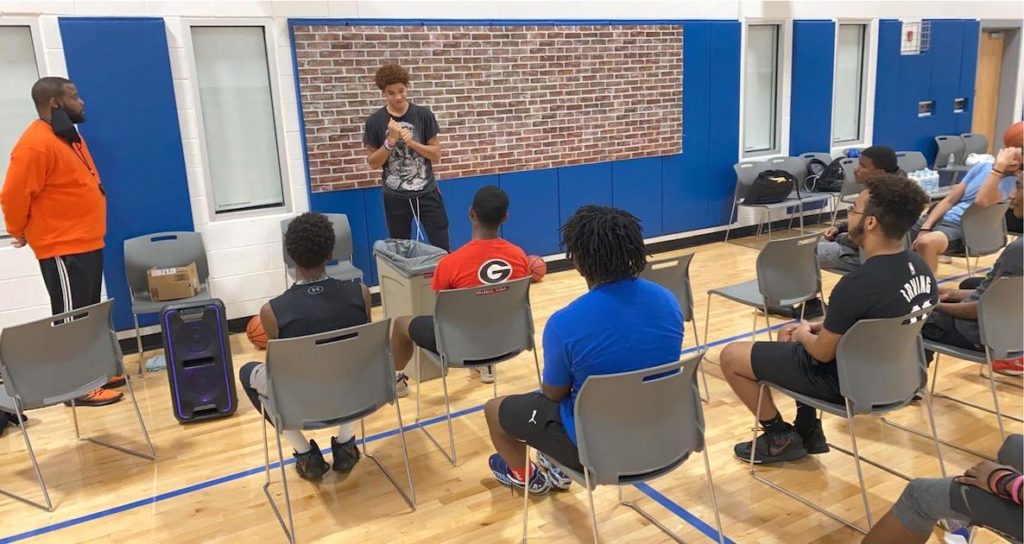 Youth take part in a meeting as part of the I Am Because We Are basketball program in Philadelphia
