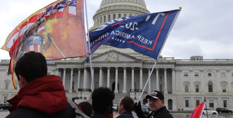 Trump supporters wave Trump flags at the capitol on January 6 2020