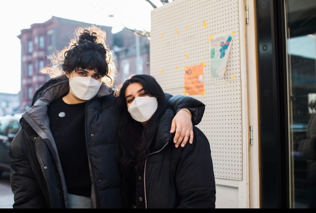 Sonia and Sonam Parikh in front of The People's Fridge