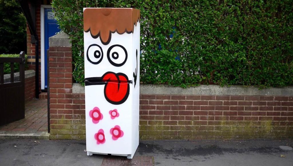 A community fridge with art painted on it