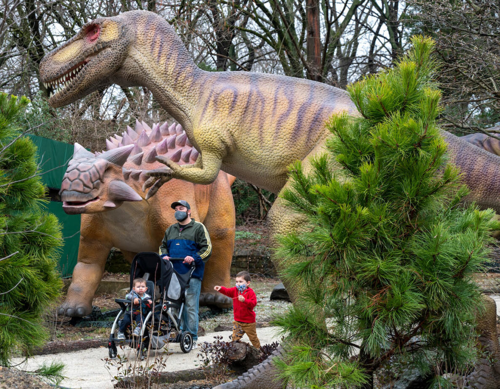 A family strolls through the dinosaur exhibit at the Philadelphia Zoo