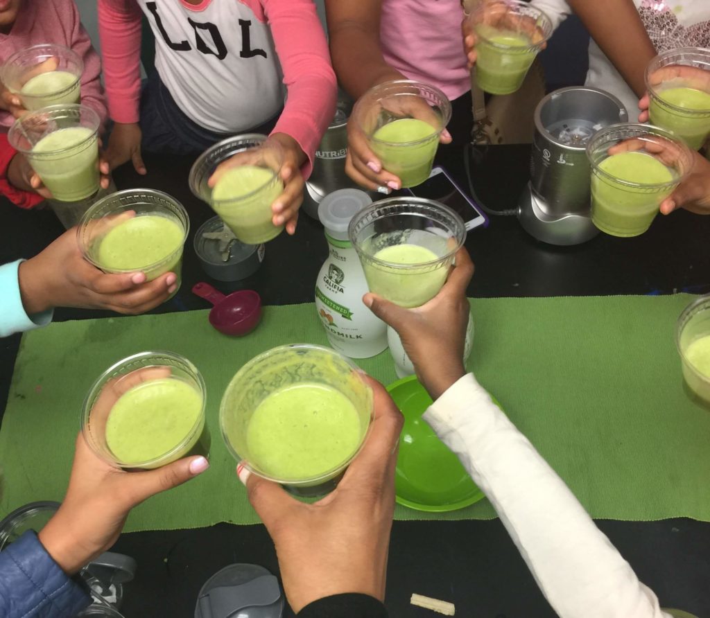 Students cheers with green juice