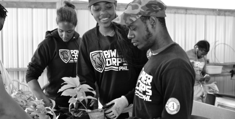 Philadelphia teens get training from PowerCorpsPHL on how to work in a greenhouse with plants.