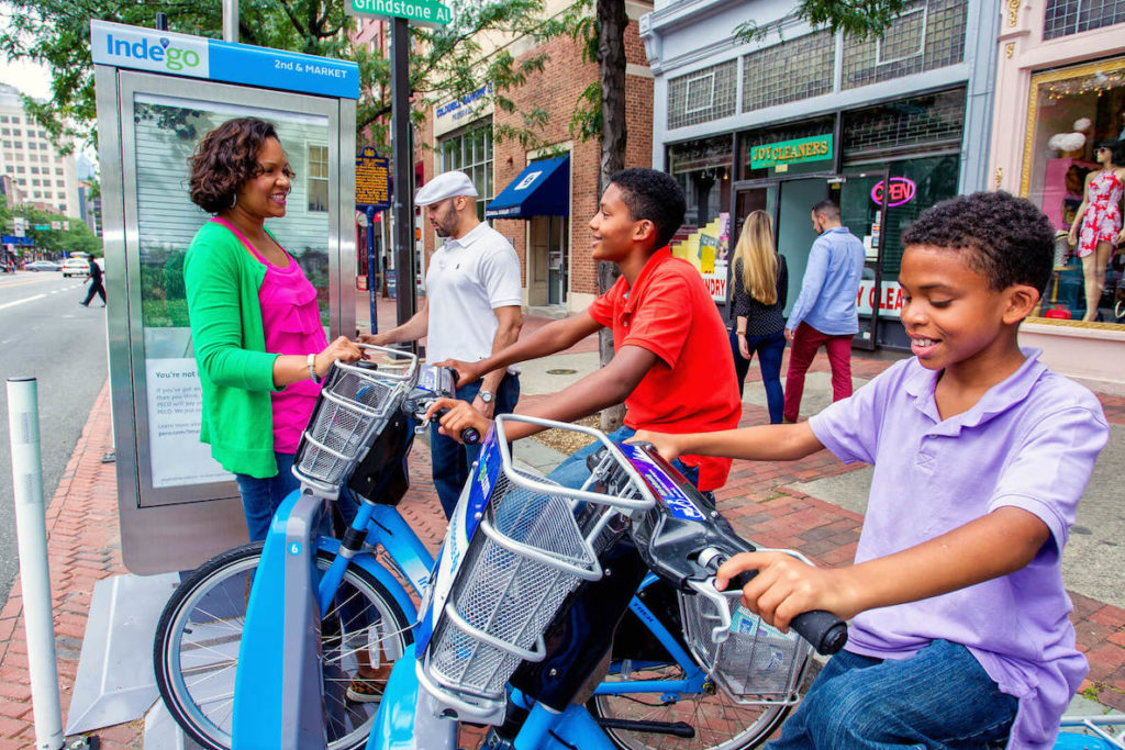 A mother and her kids check out some Indego bikes in Center City Philadelphia