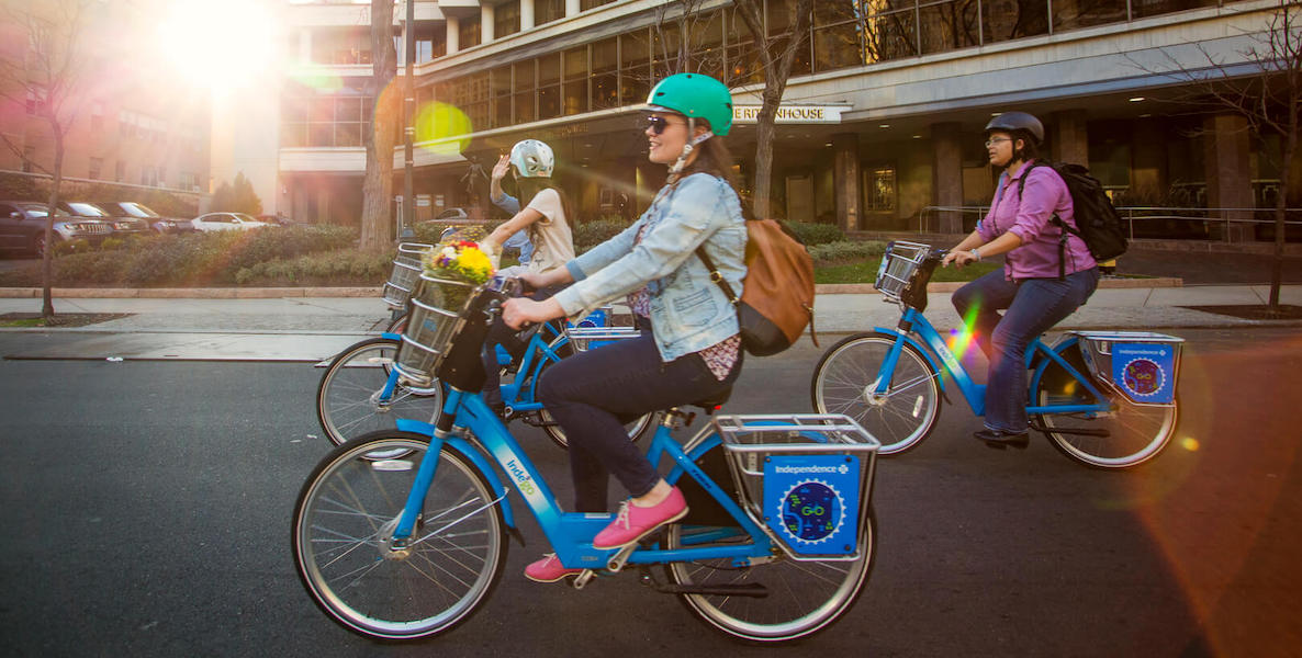 Friends cruise through the streets of Philadelphia on Indego bikes