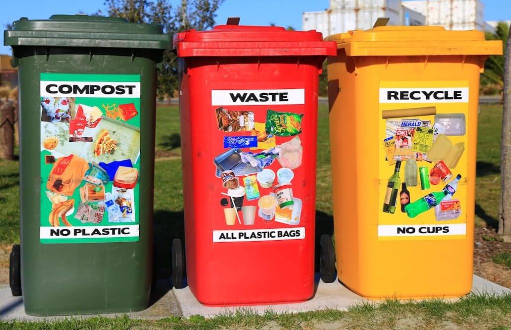 Brightly colored compost waste and recycling bins
