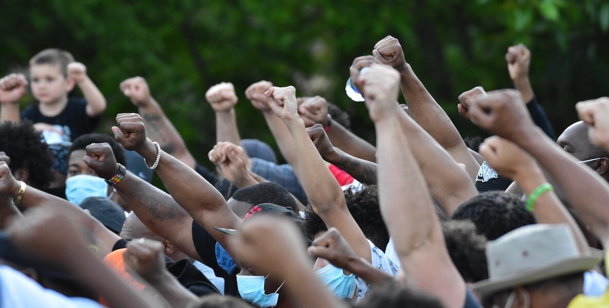 Black power fists marching in a crowd