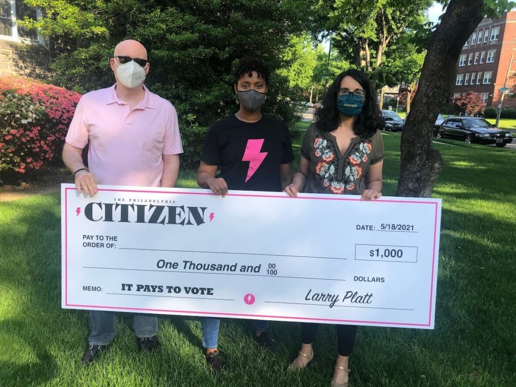 The Citizen's Larry Platt, Tia Mathisen and Roxanne Patel Shepelavy hold a check for the 2021 voter lottery