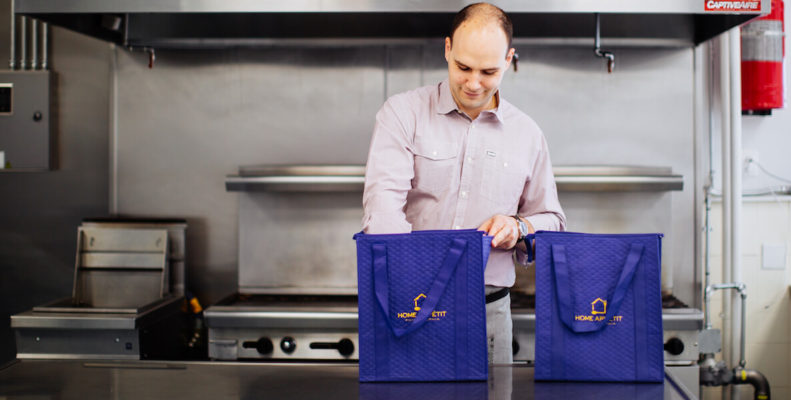 Home Appetit chef packing delivery bags in kitchen
