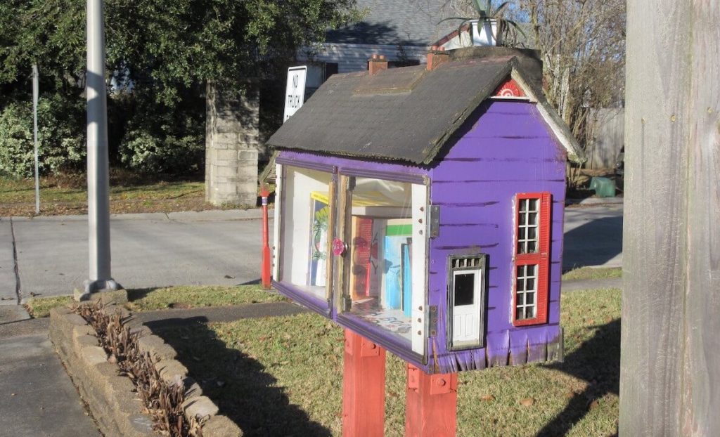 A cute purple little free library accompanies an article about how to build little free libraries