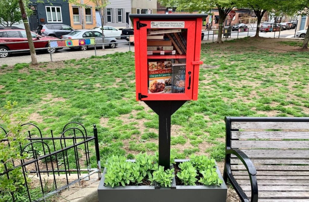 A red little free library in Cianfrani Park in Philadelphia
