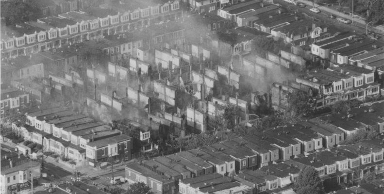 black and white photo showing destruction caused by MOVE bombing in 1985