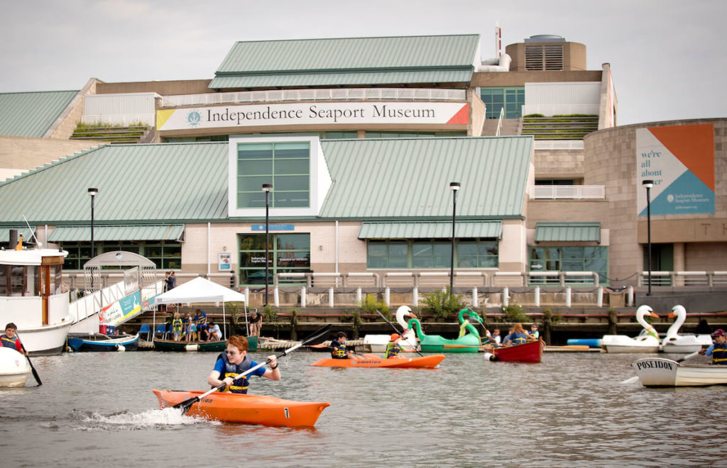 A variety of paddle boats maneuver around the Penn's Landing basin in Philadelphia
