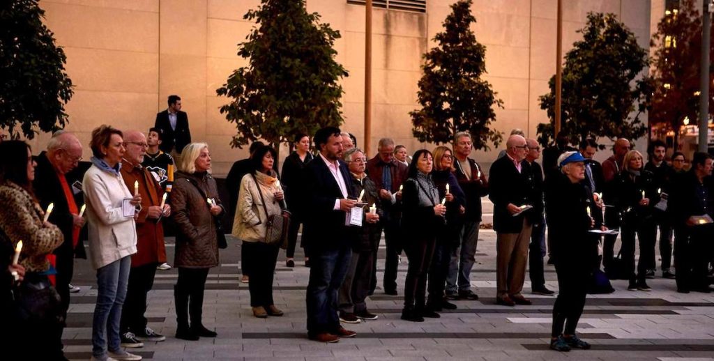 Guests participate in a candle light vigil at the Philadelphia Holocaust Remembrance Foundation