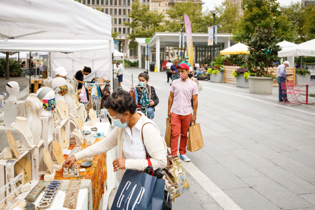 Shoppers browse goods at a vendors market at Dilworth Park in Center City, Philadelphia