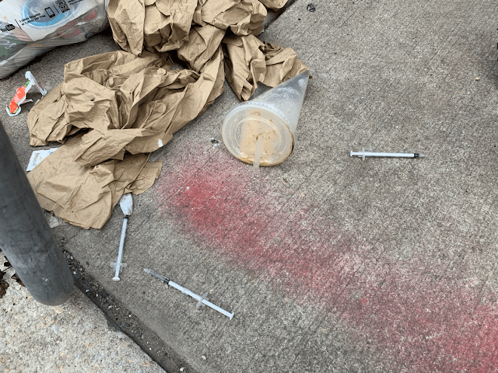 coffee cup and needles on South Philly street