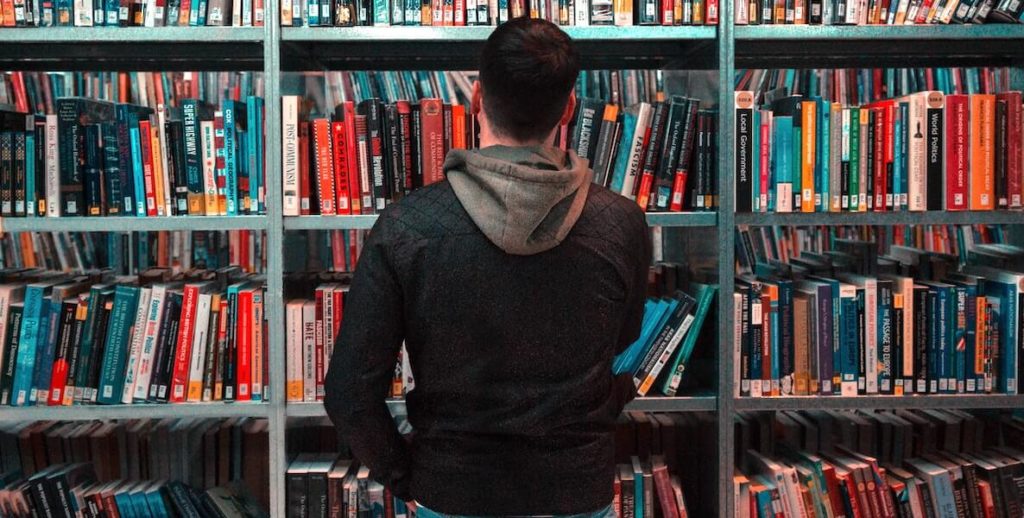 A man searches the shelves at the Free Library of Philadelphia for a book he wants to read