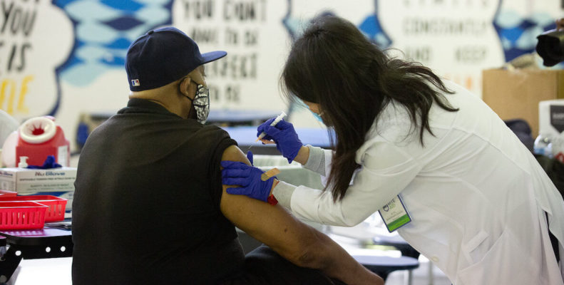 Doctor giving Philadelphian Covid-19 vaccine shot