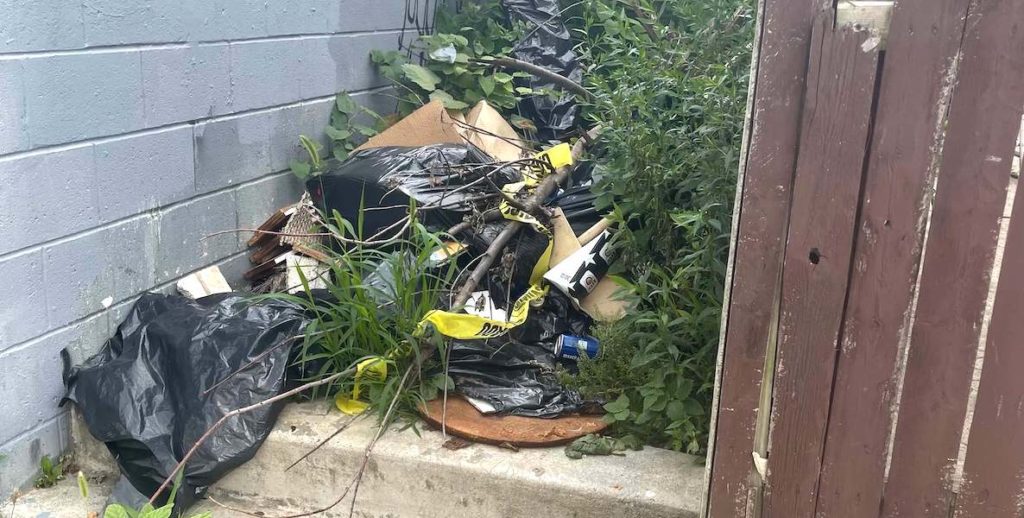 This photo of garbage in an alleyway accompanies an article about how to get the city to clean up illegal dumping sites in Philadelphia.