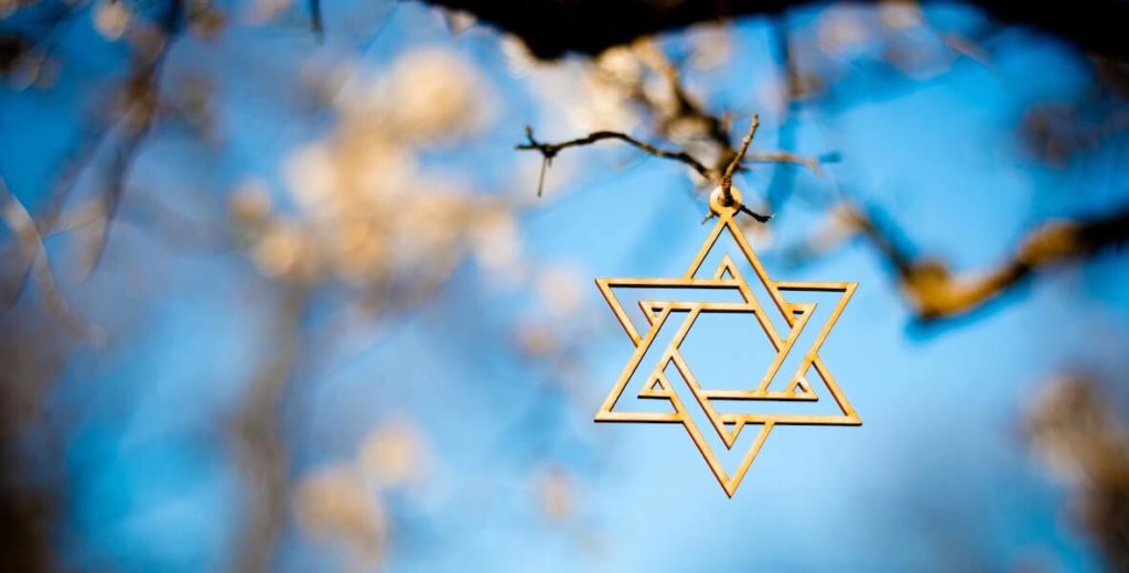 gold star of David hanging from a tree