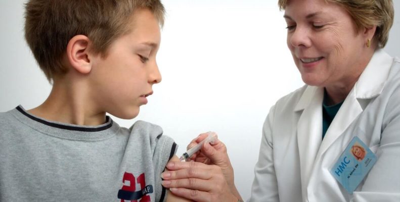 This photo of a doctor giving a young boy a shot accompanies a think piece about what we've learned so far about vaccinating kids 12 and under.