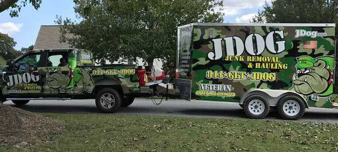 A pickup truck hauls a trailer for JDog, a veteran-owned business in Philadelphia.
