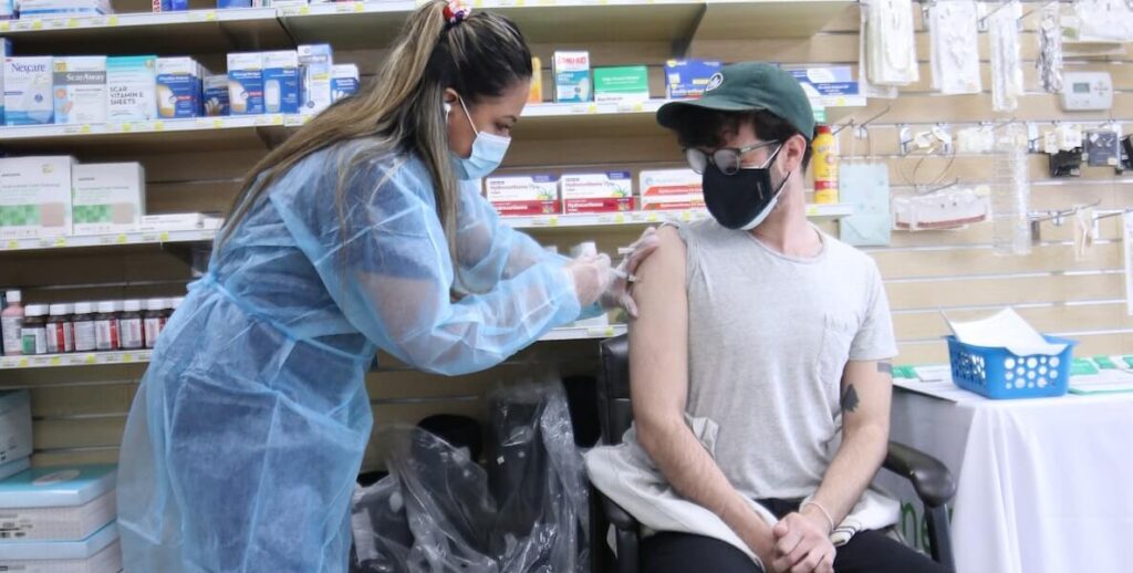 Young person being vaccinated at pharmacy