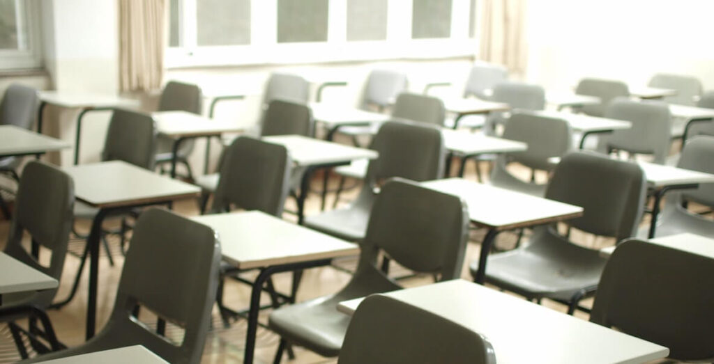Empty chairs with desks in a classroom