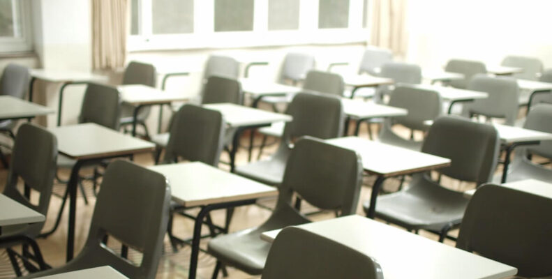 Empty chairs with desks in a classroom