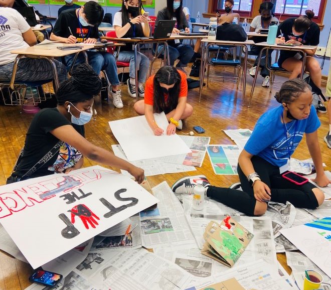 School students work on signs and other campaign materials for an anti-violence protest
