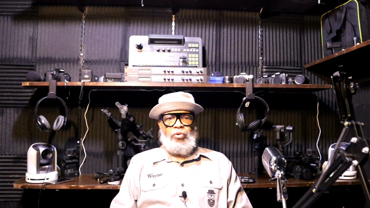 Wayne Hunter sits in front of his studio equipment , where PhillyCAM funding is essential to reach seniors and others in need.