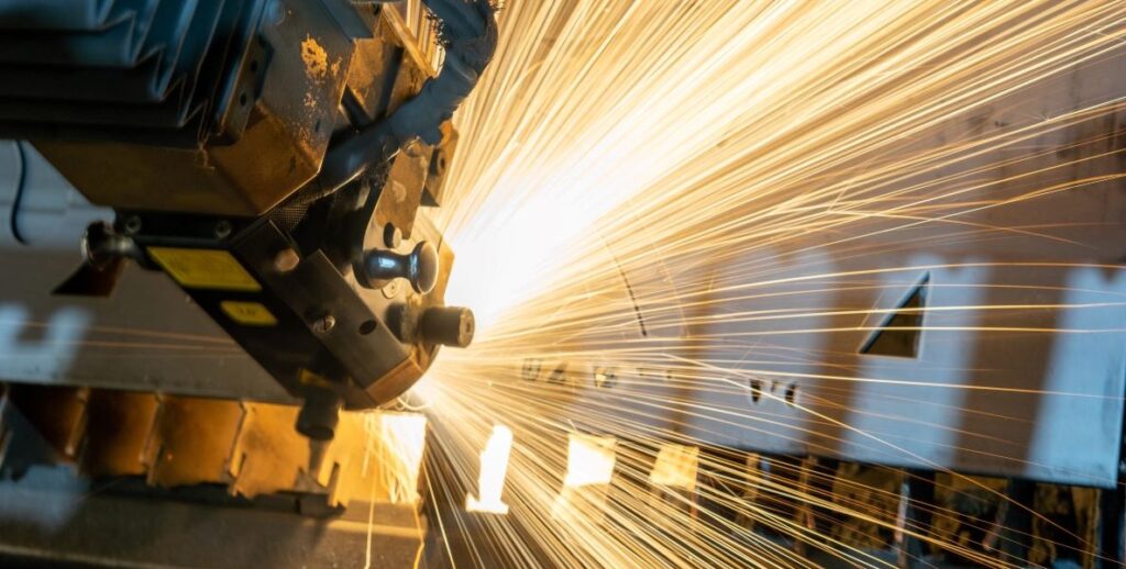 A metal manufacturing machine in operation, sparks flying