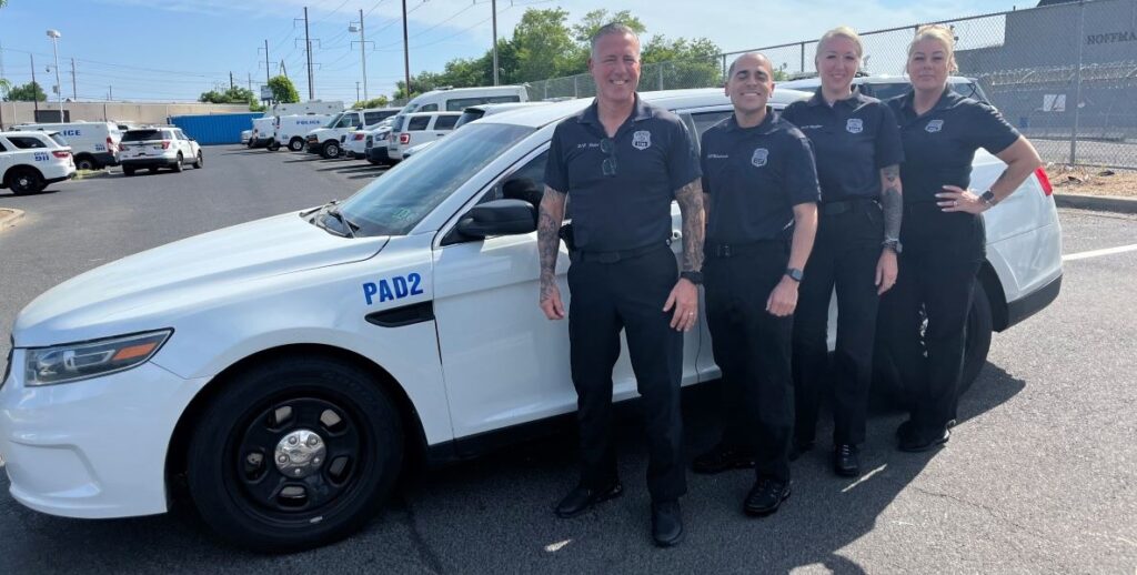 A police vehicle labeled PAD 2 along with the 4 officers who make up the ROC North PAD unit