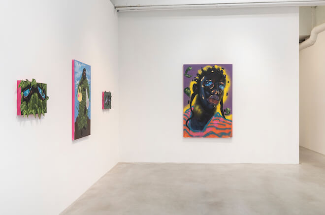 Four paintings by Patricia Renee' Thomas hang on white walls in a New York City gallery.