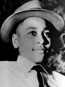Black-and-white photo of Emmett Till, wearing a shirt, tie and hat, taken by his mother Mamie Till-Mobley. His death put him in the annals of Black history.